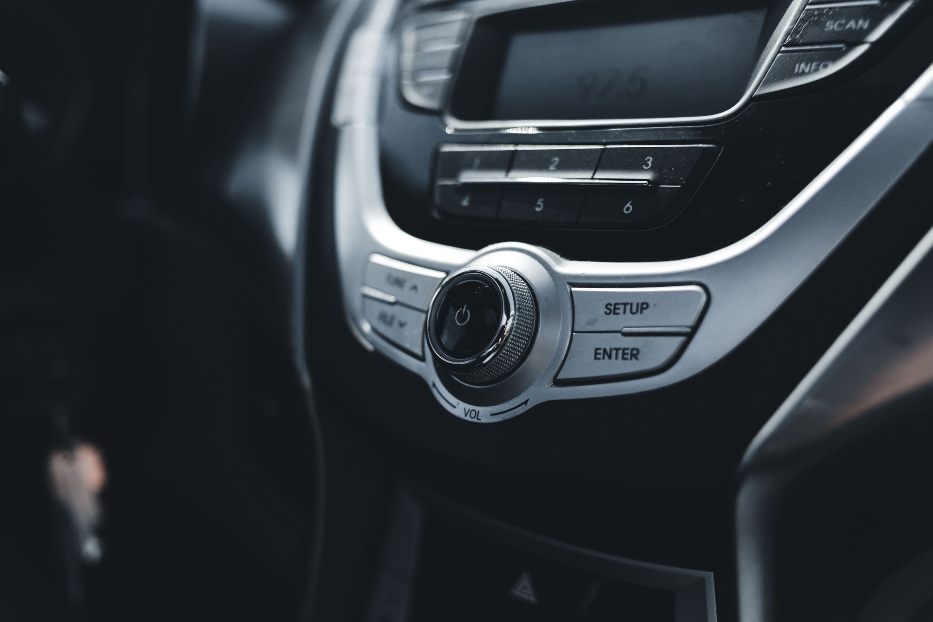 Detailed shot of sleek and elegant car stereo and AC controls.